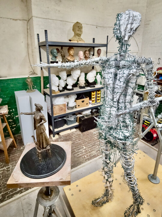 The maquette next to the full-size armature 