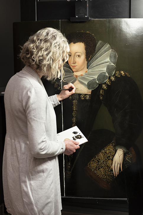 Rebecca Kench, conservator, working on the painting