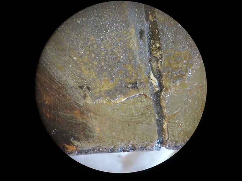 The Knightshayes Rembrandt seen under the microscope, showing overpaint going over damages
